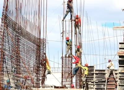 Construction worker tying rebar on site
